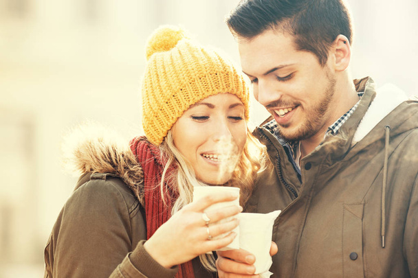 Happy Couple Having Hot Drink Outdoors. Winter Day. - Photo, image