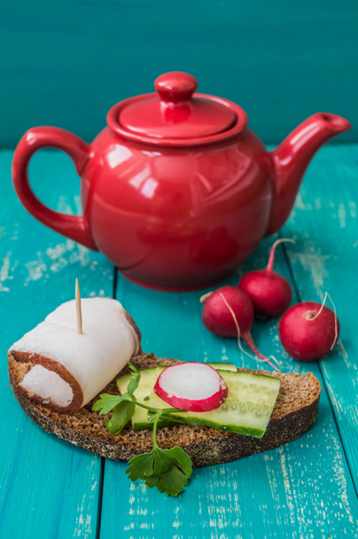 Canapes with black bread, bacon, cucumber and radish. - Photo, Image