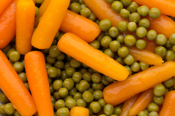 Carrots with green peas vegetable background. - Foto, Imagen