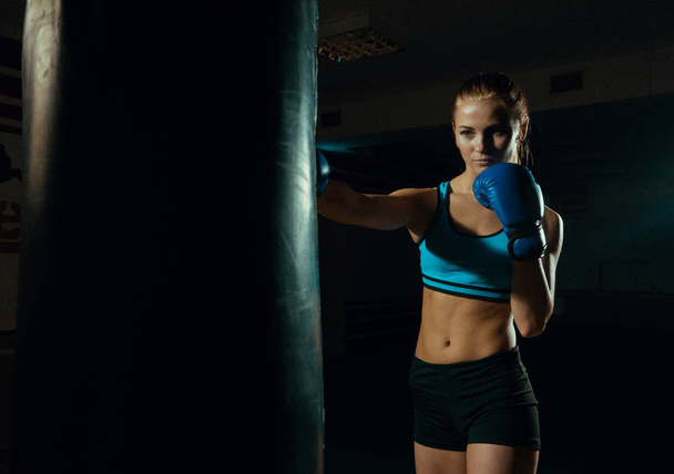 Boxing training woman in black grunge background - Fotografie, Obrázek