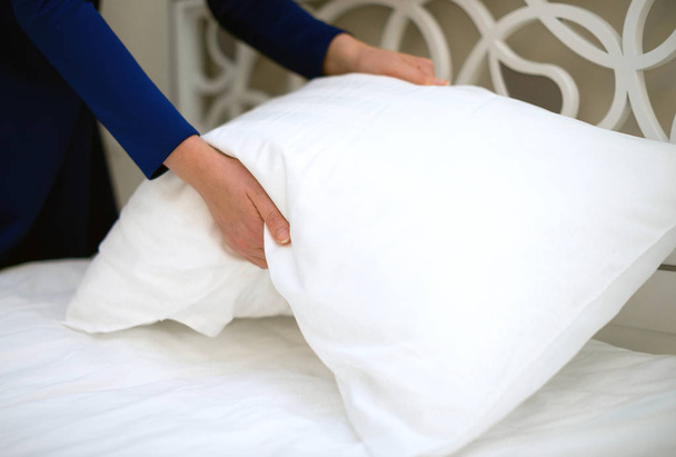 Room service. Woman making bed in hotel room. - Photo, Image