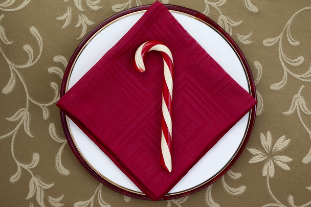 Bastón de caramelo con servilleta de mesa roja
 - Foto, imagen