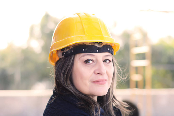 Female architect at a construction site. - 写真・画像