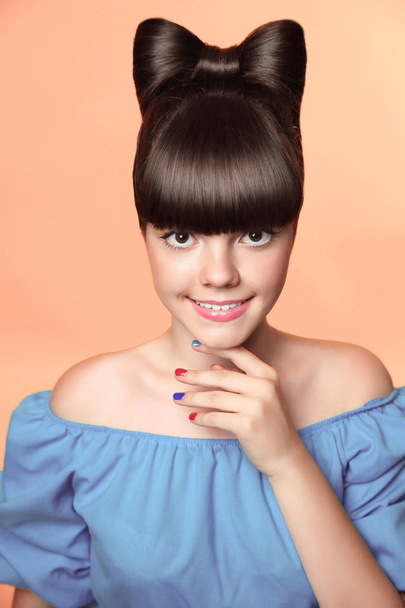 Beautiful smiling teen girl with bow hairstyle, makeup and colou - Foto, immagini
