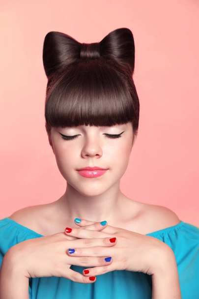 Beautiful smiling teen girl with bow hairstyle, makeup and colou - Foto, Imagen