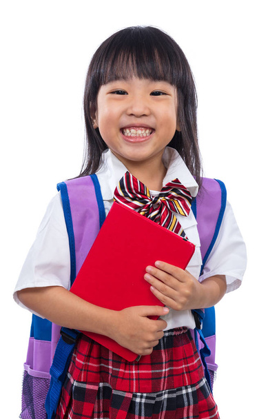 Happy Asian Chinese little girl with school bag and book - Фото, изображение