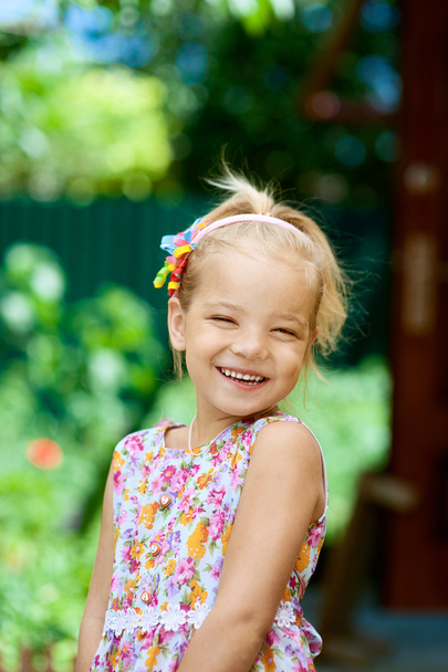 blonde beautiful smiling little girl close-up - 写真・画像