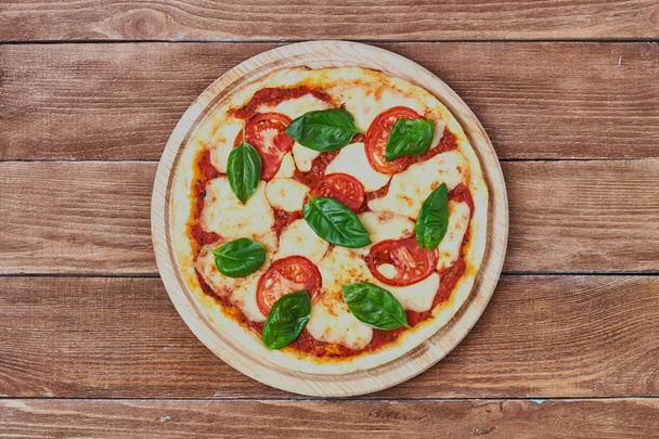 Pizza Margherita with tomatoes, mozzarella and basil  - Photo, Image
