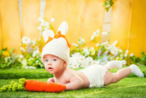 happy baby child in costume a rabbit bunny with carrot - Valokuva, kuva