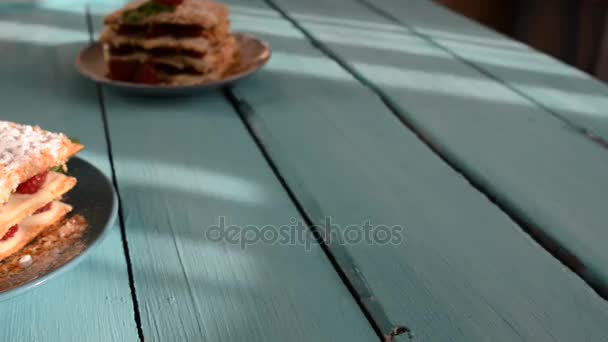 Raspberry Mille-feuille with cinnamon on a blue wooden Board - 映像、動画