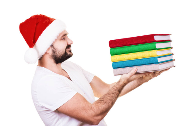 Happy man in Santa hat with a book on the White Background - Foto, afbeelding