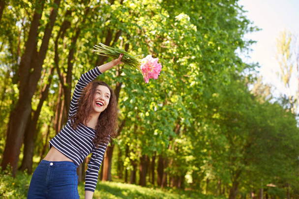 happy and cheerful girl with tulips - Fotoğraf, Görsel