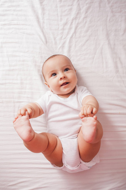 Portrait of a baby lying on the bed - Foto, Imagem