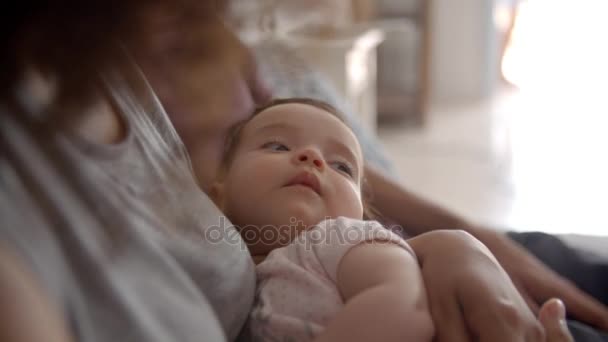 Parents Cuddling Baby Daughter - Кадры, видео