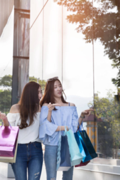 счастливая азиатка с красочными сумками для покупок в отделении стор
 - Фото, изображение