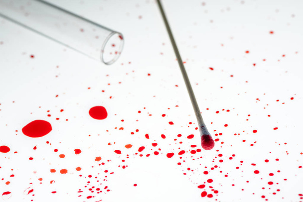 Cotton swab and blood drips in crime scene investigation - 写真・画像