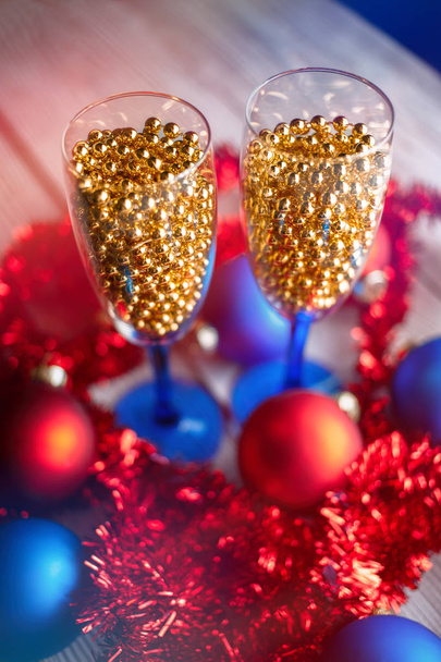 テーブルを提供します。シャンパンと新しい年の前夜パーティーのテーブル。シャンパン グラス。お祝いテーマ。新しい dekor ビーズ、シャンパンの代わりにガーランド。お祝いグラス シャンパンで. - 写真・画像