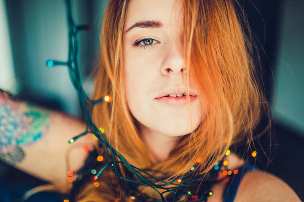 redhead woman with garland decoration - Foto, Imagen