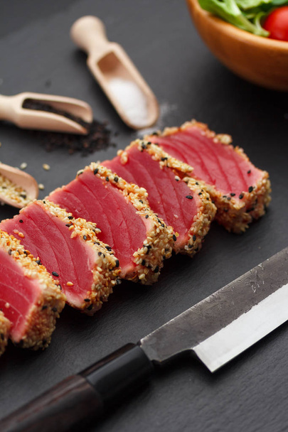 Grilled tuna fillet with sesame on a stone plate. - Foto, Imagen