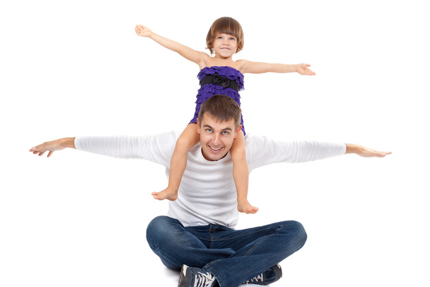 Handsome father with his little daughter on his shoulders happil - Photo, Image