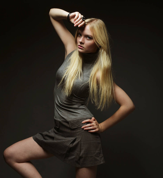 Portrait of beautiful young blonde girl in black dress. - Foto, afbeelding
