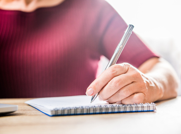 kobieta pisząca w notatniku - Zdjęcie, obraz