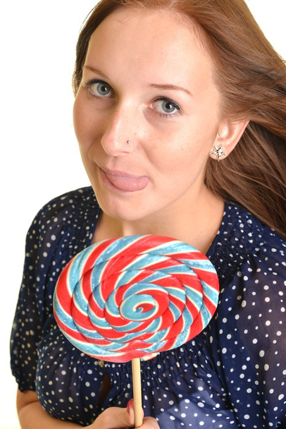 Woman with a lollipop, isolated against white - Photo, image