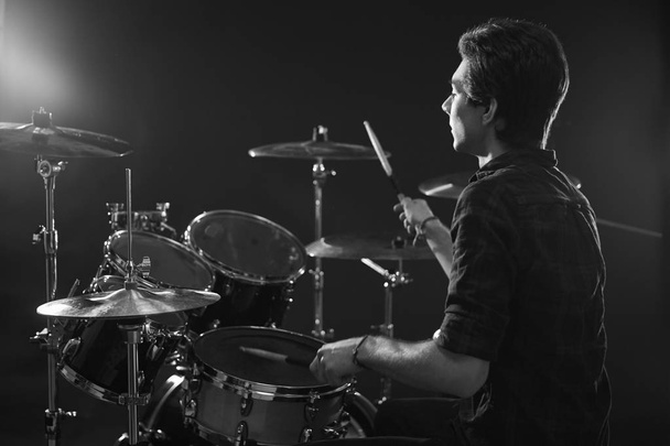 Drummer Playing Drum Kit In Studio - 写真・画像