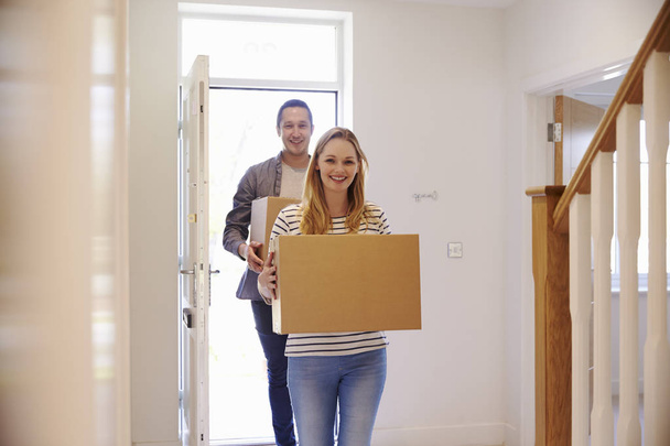 Couple Carrying Boxes Into New Home - Foto, Bild