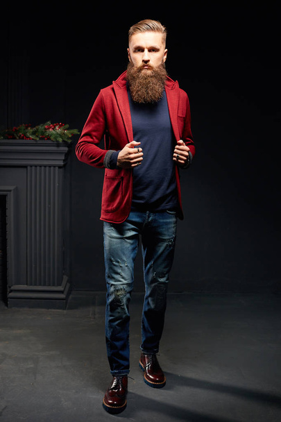 Young model man with long beard posing in dark studio - Foto, Bild