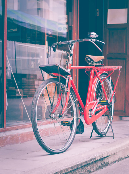 Red bicycle standing on street - Fotografie, Obrázek