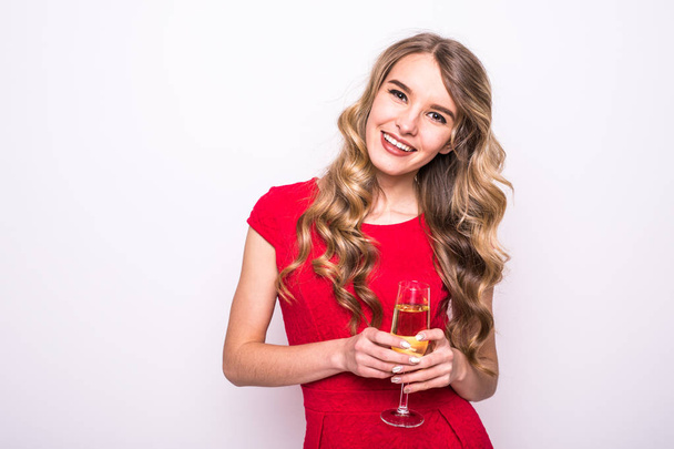 Nainen punaisessa mekossa juo samppanjaa valkoisella taustalla
 - Valokuva, kuva