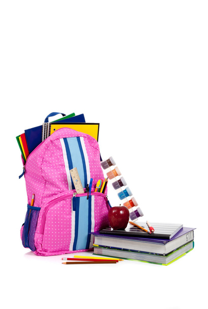 Pink backpack with school supplies with copy space - Фото, изображение