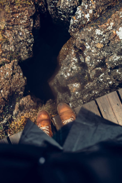 Legs in boots standing on lava  - 写真・画像