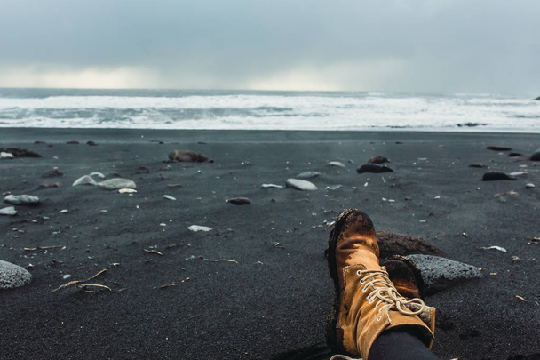 Legs in boots on seashore - Φωτογραφία, εικόνα