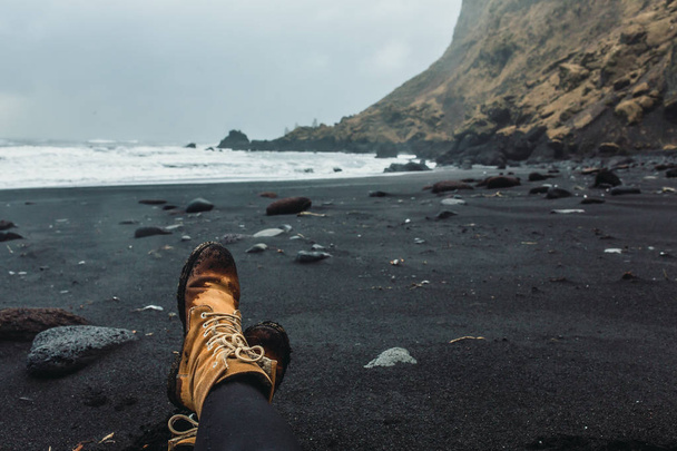 Legs in boots on seashore - Photo, Image