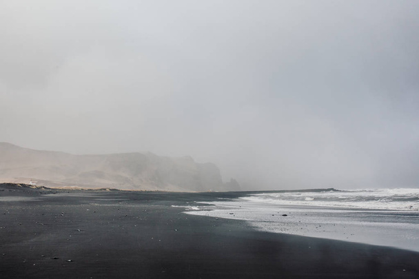 Seashore with black sand and stones - Foto, Imagem