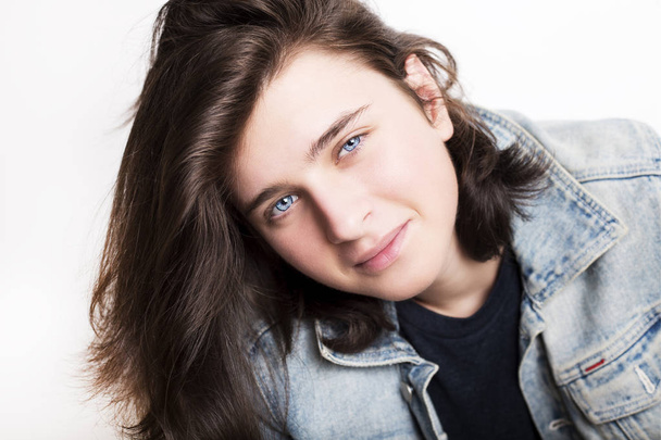 Fashion portrait of a beautiful teenager wearing jeans jacket - Fotó, kép