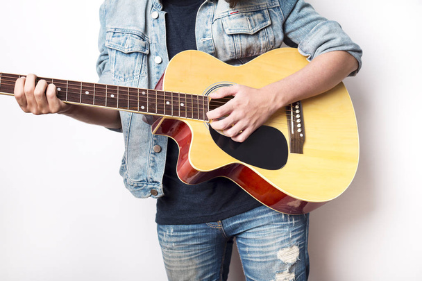 Portrait of a teenager playing guitar in studio  - Φωτογραφία, εικόνα