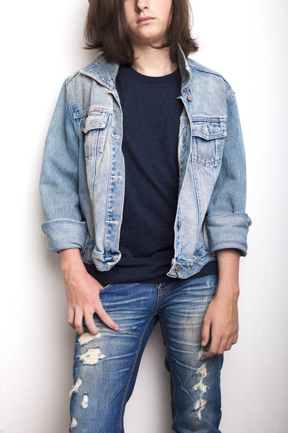 Fashion portrait of the young man wearing jeans jacket - 写真・画像
