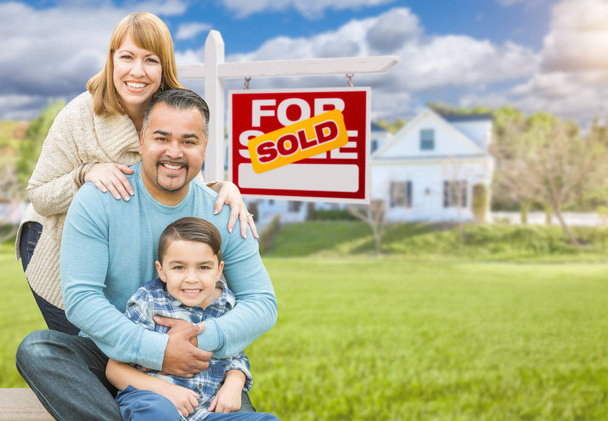 Mixed Race Family In Front of House and Sold For Sale Real Estate Sign - Photo, Image