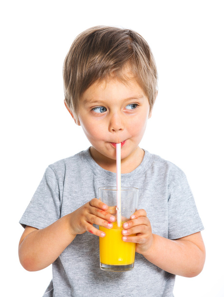 Portrait of little boy drinking orange juice - Fotografie, Obrázek