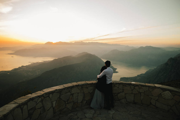 honeymoon couple kiss and embrace at sunset - Photo, Image
