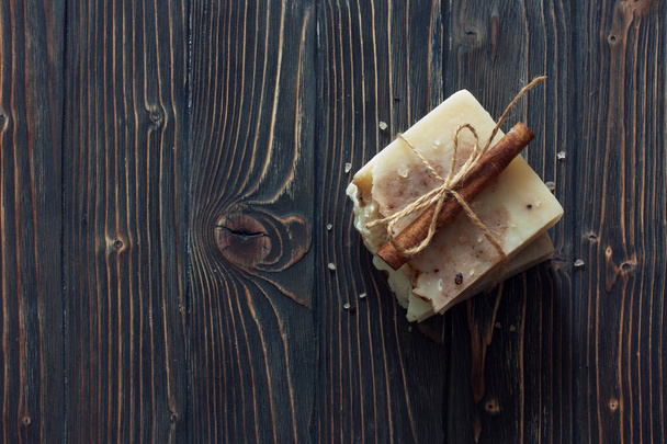 Bars of handmade soap over dark wood background. Top view. - Фото, изображение
