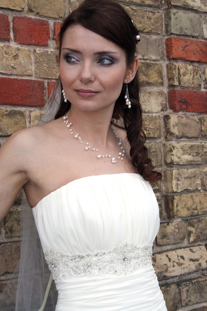 Bride on background of brick wall. - Photo, Image