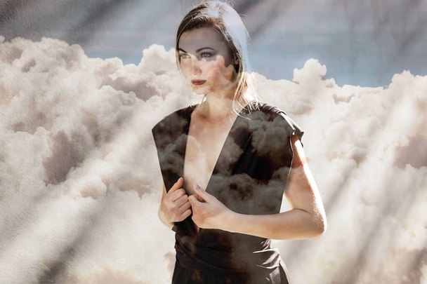 Double exposure of gorgeous woman walking and cloudscape - Foto, imagen
