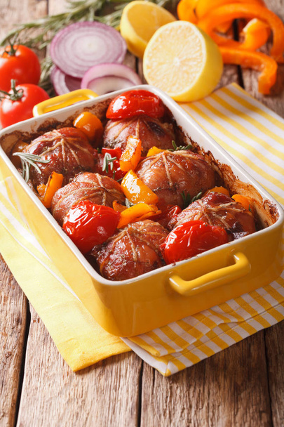 Ballotine rabbit baked with tomatoes, pepper and rosemary close  - Photo, Image
