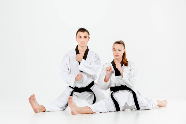 The karate girl and boy with black belts - Foto, imagen