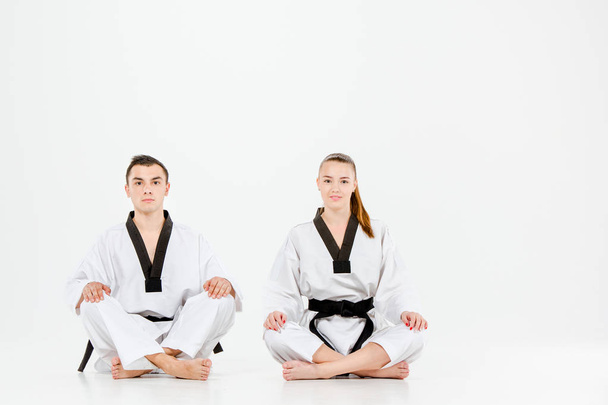 The karate girl and boy with black belts - Foto, afbeelding