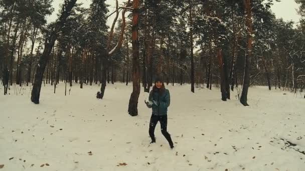 Young woman throws snowball hitting camera slow motion - Footage, Video